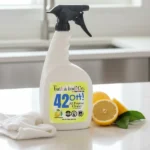 Balence 42OH! All-Purpose Cleaner spray bottle on a clean kitchen counter with fresh lemon slices and green leaves, bright daylight in the background.