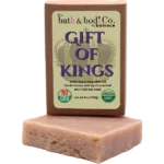 Balence Gift of Kings handmade soap on rustic wood with frankincense resin, myrrh chunks, cedar sprigs, sage leaves, and warm golden candlelight.