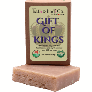 Balence Gift of Kings handmade soap on rustic wood with frankincense resin, myrrh chunks, cedar sprigs, sage leaves, and warm golden candlelight.