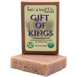 Balence Gift of Kings handmade soap on rustic wood with frankincense resin, myrrh chunks, cedar sprigs, sage leaves, and warm golden candlelight.