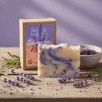 Balence Lavender Remixed handmade soap bar on a rustic wooden surface with fresh lavender sprigs, dried buds, and soft golden sunlight in the background.