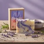 Balence Lavender Remixed handmade soap bar on a rustic wooden surface with fresh lavender sprigs, dried buds, and soft golden sunlight in the background.