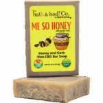 Balence Me So Honey handmade soap on rustic wood with a honey dipper, goat milk jar, rolled oats, and honeycomb in warm golden sunlight.