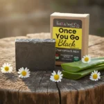 Balence Once You Go Black Chamomile & Aloe solid black soap bar with label, styled with fresh chamomile flowers and aloe leaf on rustic wood in soft golden sunlight.