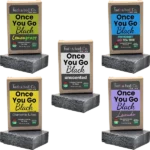 Balence Once You Go Black activated charcoal soap collection — solid black handmade bars with labels for Unscented, Lavender, Lemongrass, Peppermint & Tea Tree, and Chamomile & Aloe — displayed with herbs, flowers, and charcoal chunks on rustic wood.