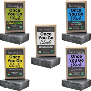 Balence Once You Go Black activated charcoal soap collection — solid black handmade bars with labels for Unscented, Lavender, Lemongrass, Peppermint & Tea Tree, and Chamomile & Aloe — displayed with herbs, flowers, and charcoal chunks on rustic wood.