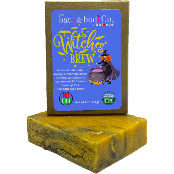 Balence Witch’s Brew handmade soap bar on an aged wooden table with candles, herbs, cinnamon sticks, and wisps of smoke creating a mystical atmosphere.