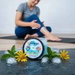 Balence Ice Muscle Gel jar with a cool blue gel and clear label sits on a slate surface surrounded by scattered ice chips, fresh mint leaves, and arnica sprigs. In the softly blurred background, a fit person in athletic wear massages gel onto their calf post-workout in bright, cool daylight.